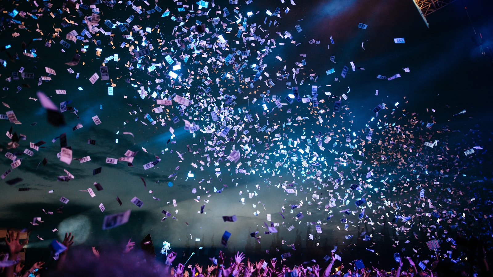 Confetti falling over a crowd at a concert