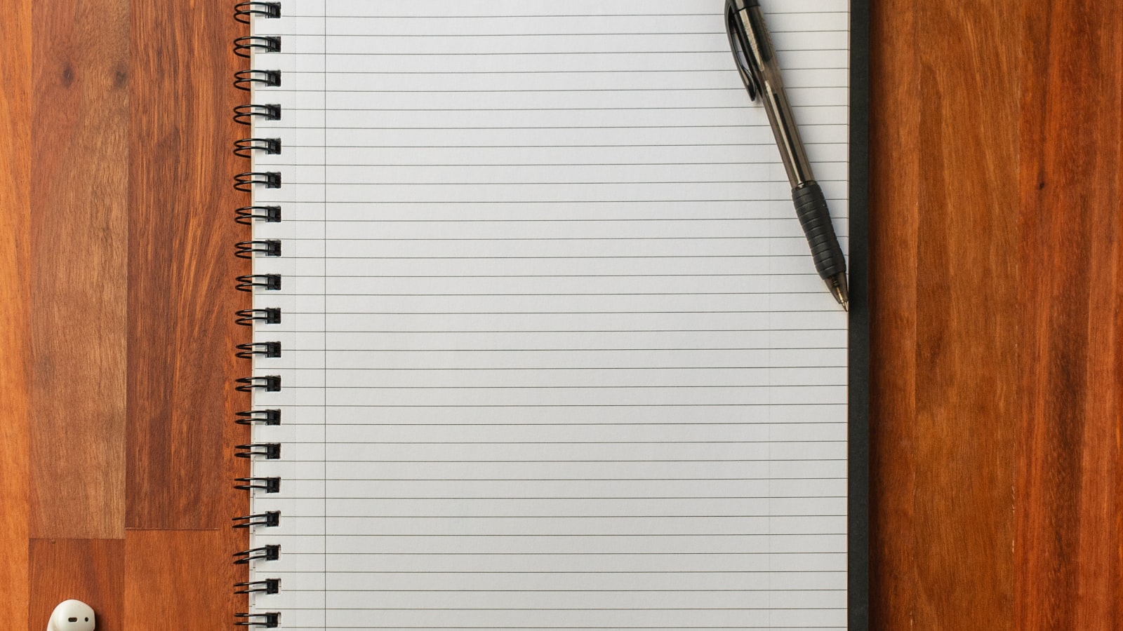 A pen on a notebook on a desk